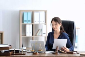 A table with legal documents, photographs, and physical evidence displayed in a courtroom setting.